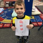 child holding picture, daycare programs