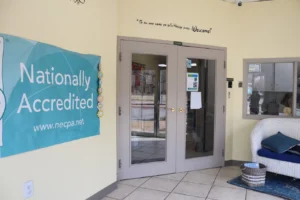 Front entry at Adventure Learning Center with NECPA accreditation sign