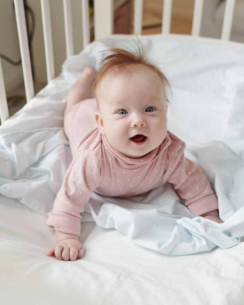 Smiling baby in a safe infant care setting at Adventure Learning Center