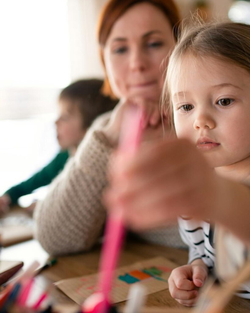 Adventure Learning Center preschool and pre-k children drawing with teacher support